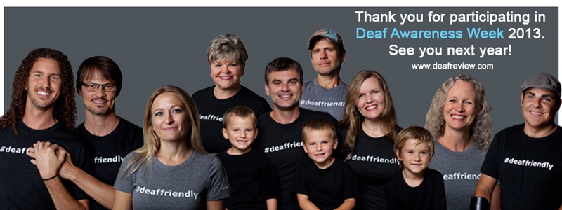A group of Deaf people wearing gray and black #deaffriendly shirts